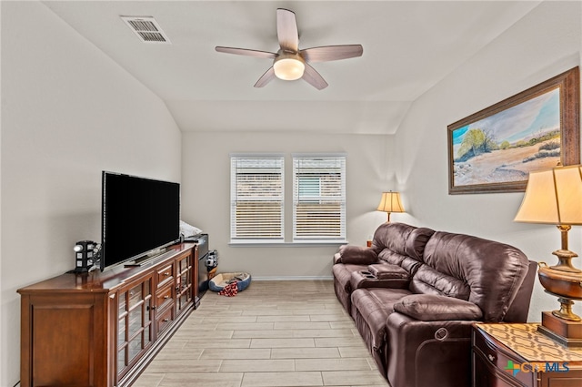 living room featuring lofted ceiling and ceiling fan