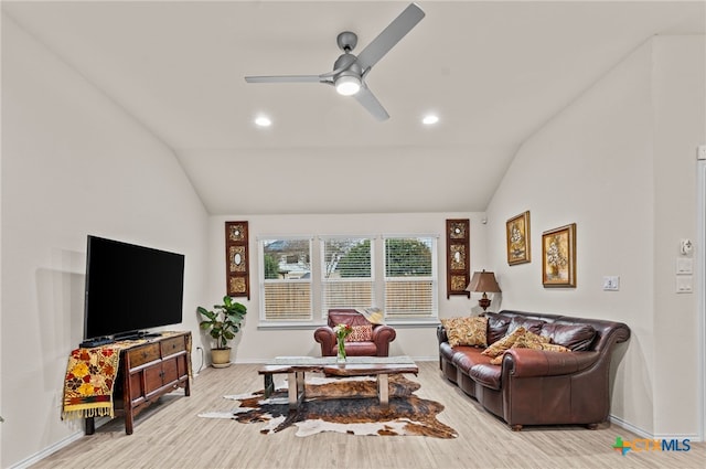 living room featuring vaulted ceiling, light hardwood / wood-style floors, and ceiling fan