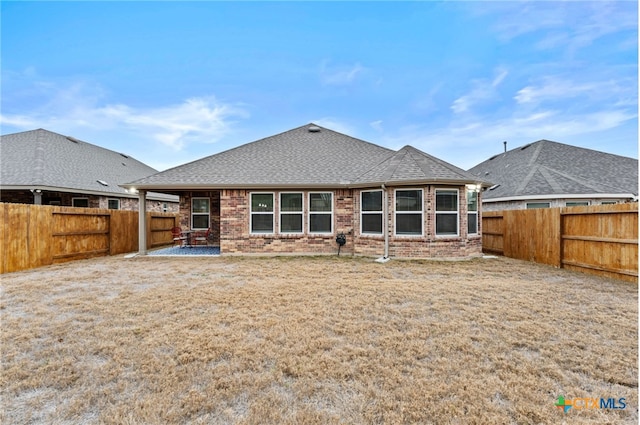 back of house with a patio and a yard