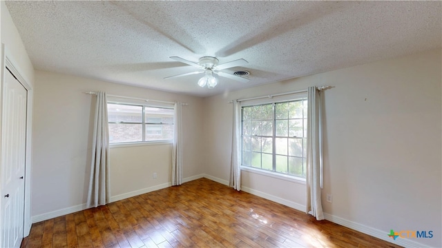 107 Hampton Ct, Victoria, TX 77904 - unfurnished bedroom with hardwood / wood-style flooring, a textured ceiling, a closet, and a ceiling fan