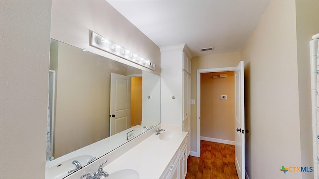 107 Hampton Ct, Victoria, TX 77904 - full bathroom with double vanity and wood finished floors