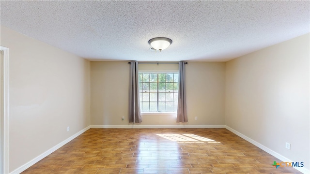 107 Hampton Ct, Victoria, TX 77904 - empty room featuring light wood finished floors and a textured ceiling