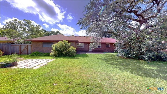 107 Hampton Ct, Victoria, TX 77904 - back of house featuring brick siding and a patio area