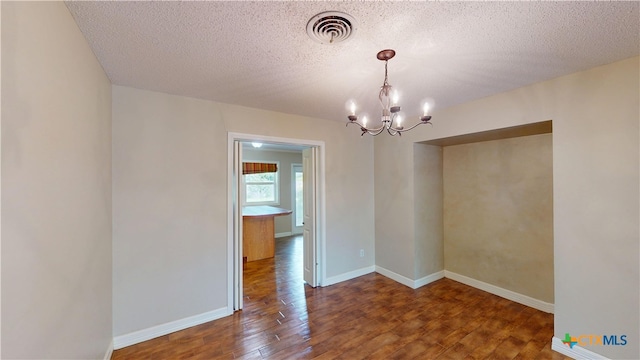 107 Hampton Ct, Victoria, TX 77904 - spare room with wood finished floors, a chandelier, and a textured ceiling