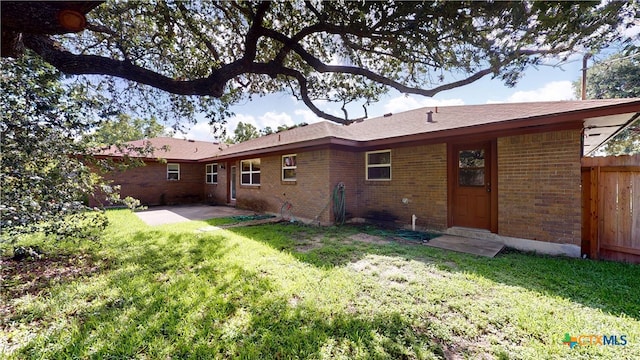 107 Hampton Ct, Victoria, TX 77904 - rear view of house with brick siding and a patio