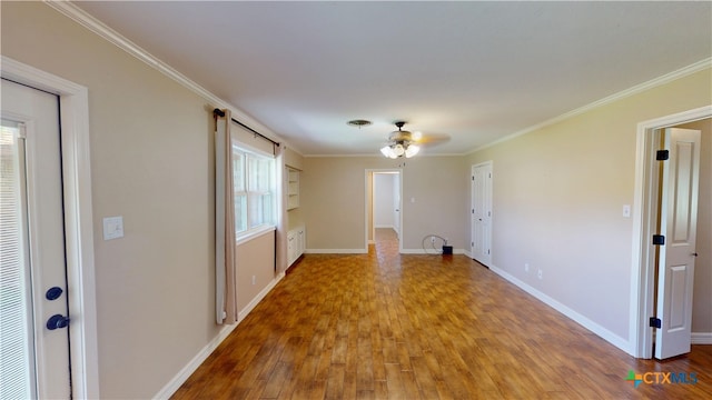 107 Hampton Ct, Victoria, TX 77904 - unfurnished living room featuring wood finished floors, a ceiling fan, and ornamental molding