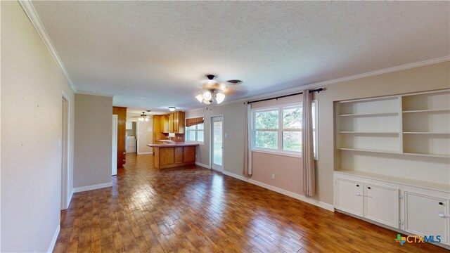 107 Hampton Ct, Victoria, TX 77904 - unfurnished living room featuring crown molding, a textured ceiling, a ceiling fan, and hardwood / wood-style floors