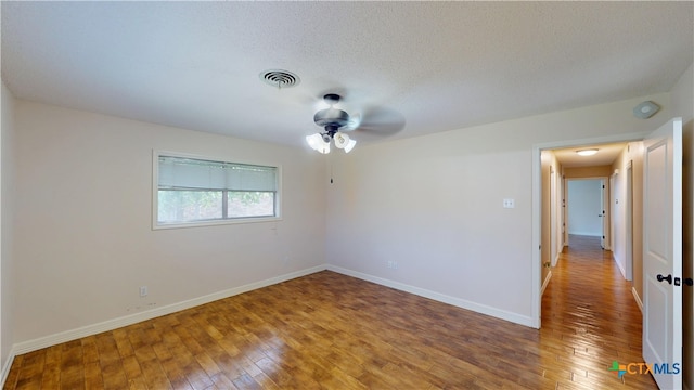 107 Hampton Ct, Victoria, TX 77904 - unfurnished room featuring light wood-type flooring, ceiling fan, a smoke detector, and a textured ceiling