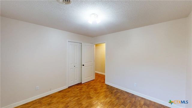 107 Hampton Ct, Victoria, TX 77904 - unfurnished room featuring wood finished floors and a textured ceiling