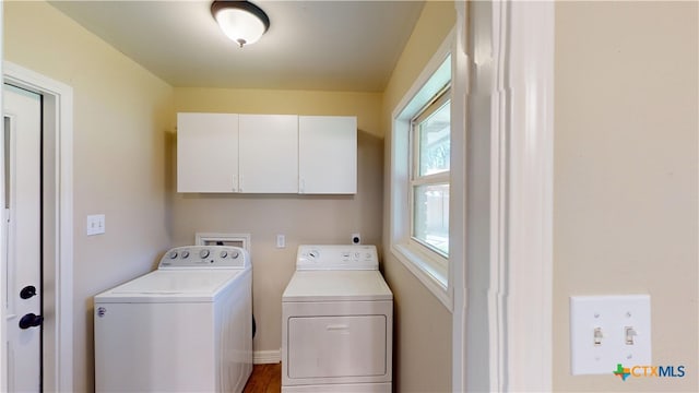 107 Hampton Ct, Victoria, TX 77904 - washroom featuring washer and clothes dryer, cabinet space, and wood finished floors
