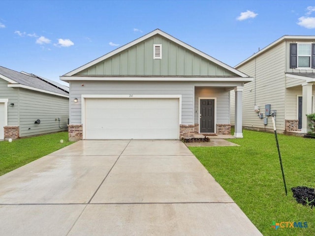 craftsman inspired home featuring brick siding, an attached garage, board and batten siding, driveway, and a front lawn