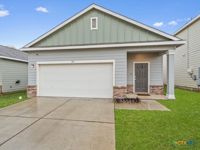 view of front of home featuring an attached garage, brick siding, concrete driveway, a front lawn, and board and batten siding