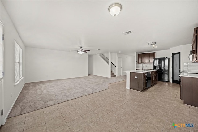 306 W Gemini Ln, Killeen, TX 76542 - kitchen featuring black appliances, light carpet, dark brown cabinetry, light countertops, and open floor plan