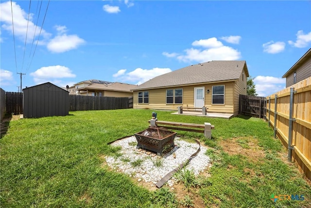 306 W Gemini Ln, Killeen, TX 76542 - rear view of property with a storage unit, a fenced backyard, and a fire pit