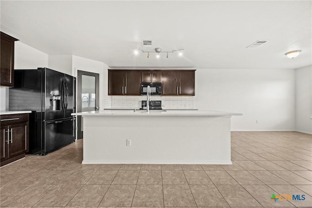 306 W Gemini Ln, Killeen, TX 76542 - kitchen with black appliances, backsplash, light countertops, light tile patterned flooring, and a center island with sink