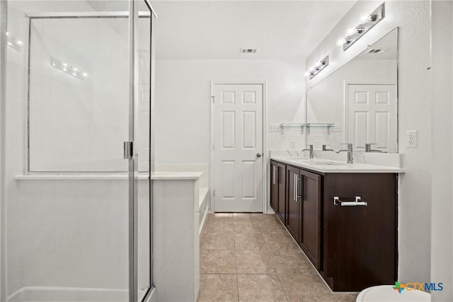 306 W Gemini Ln, Killeen, TX 76542 - full bath featuring double vanity, a shower stall, tile patterned flooring, and a bath