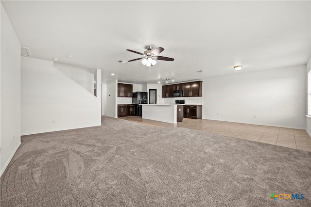 306 W Gemini Ln, Killeen, TX 76542 - unfurnished living room featuring light carpet, ceiling fan, and light tile patterned flooring
