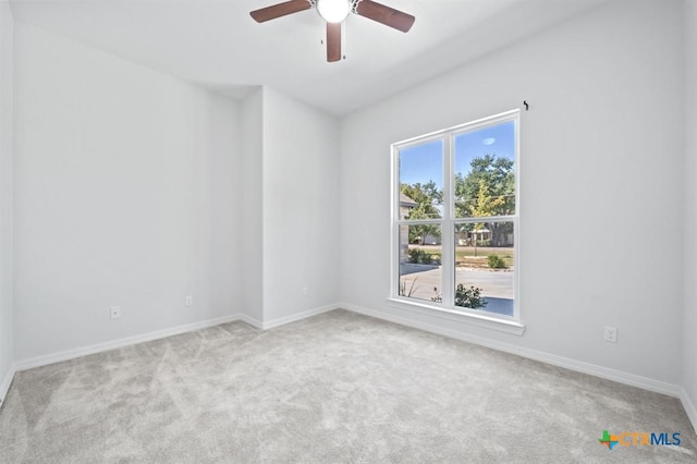 unfurnished room with ceiling fan and light colored carpet