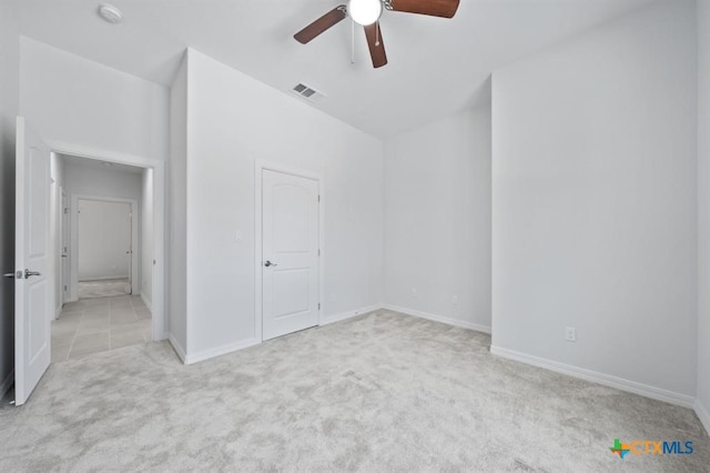 unfurnished bedroom with ceiling fan and light carpet