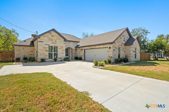 view of front of home with a front lawn and a garage