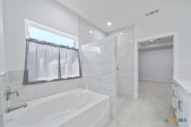 bathroom featuring vanity and plus walk in shower