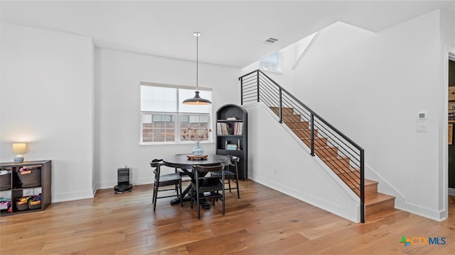 dining area with hardwood / wood-style flooring