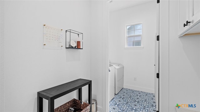 washroom featuring washer and dryer and cabinets