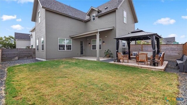 back of house featuring a gazebo, a patio, an outdoor hangout area, and a lawn