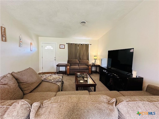 living room featuring visible vents, a textured ceiling, carpet, and vaulted ceiling