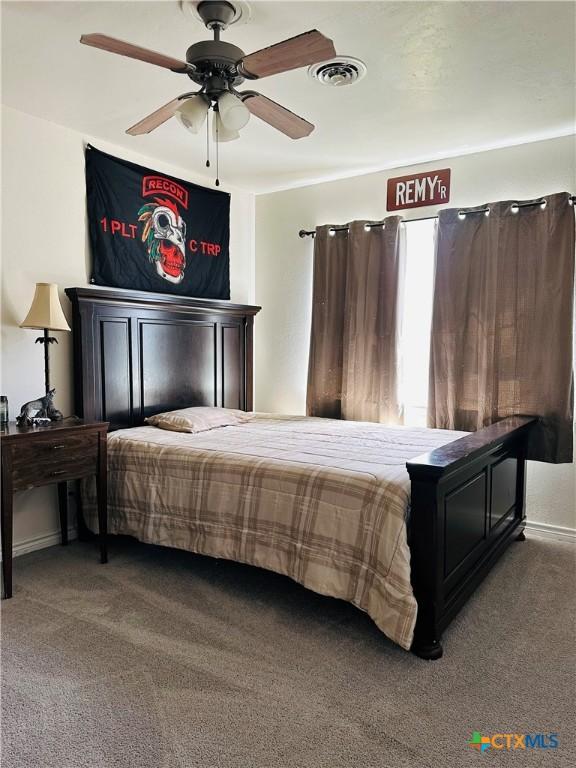 bedroom with visible vents, ceiling fan, and carpet floors