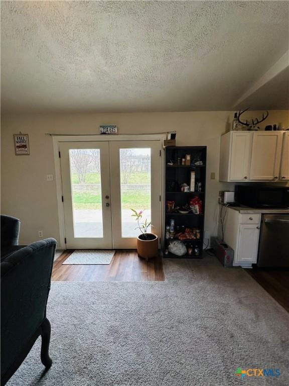 doorway to outside featuring french doors and a textured ceiling