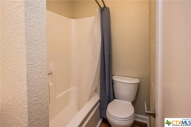 bathroom with toilet and shower / tub combo