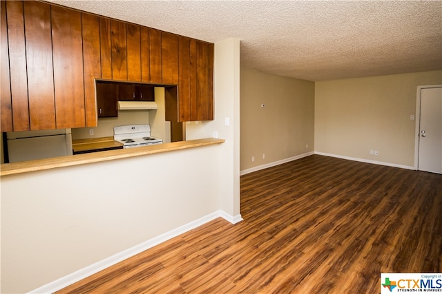 kitchen with a textured ceiling, white range, dark wood-type flooring, and fridge