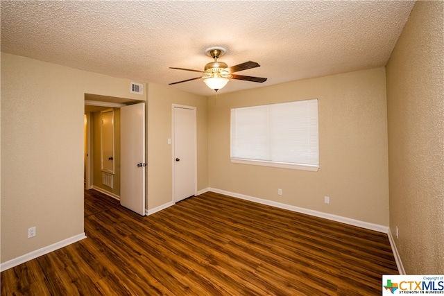 unfurnished room featuring a textured ceiling, dark hardwood / wood-style flooring, and ceiling fan