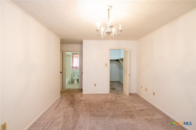 carpeted empty room featuring a notable chandelier and crown molding