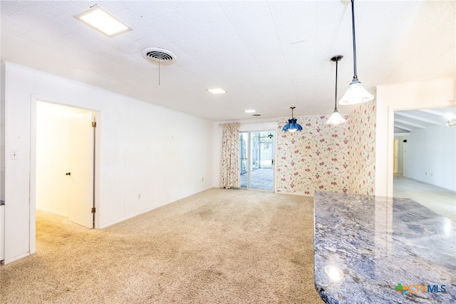 unfurnished living room featuring light carpet