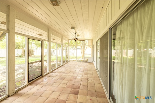 unfurnished sunroom featuring ceiling fan and wooden ceiling