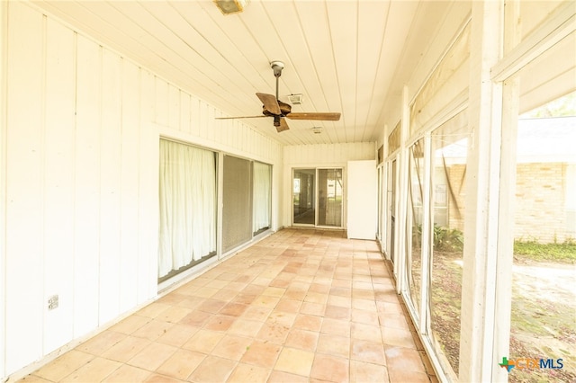 unfurnished sunroom with ceiling fan and wood ceiling