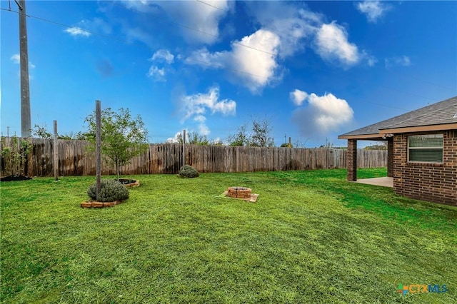 view of yard featuring an outdoor fire pit and a fenced backyard
