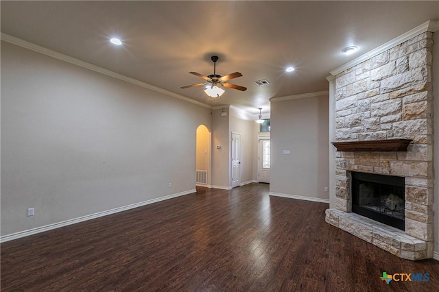 unfurnished living room featuring ornamental molding, arched walkways, visible vents, a ceiling fan, and wood finished floors