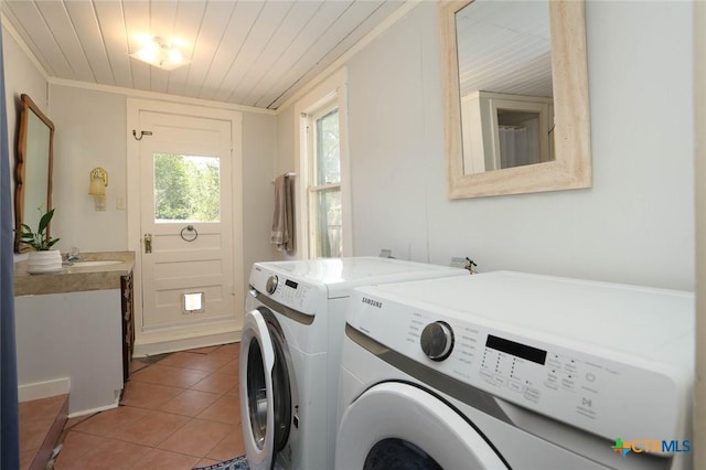 clothes washing area featuring wood ceiling, crown molding, sink, light tile patterned floors, and separate washer and dryer