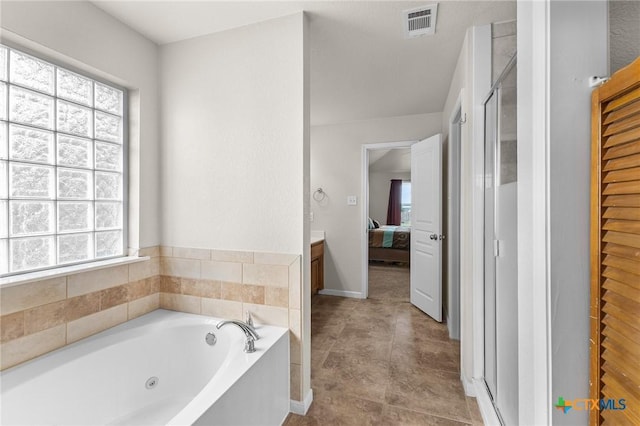 820 Thomas St, Copperas Cove, TX 76522 - bathroom with healthy amount of natural light, ensuite bathroom, a tub with jets, and a stall shower