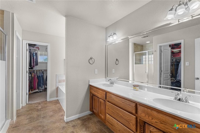 820 Thomas St, Copperas Cove, TX 76522 - full bath featuring a spacious closet, a stall shower, double vanity, a garden tub, and baseboards