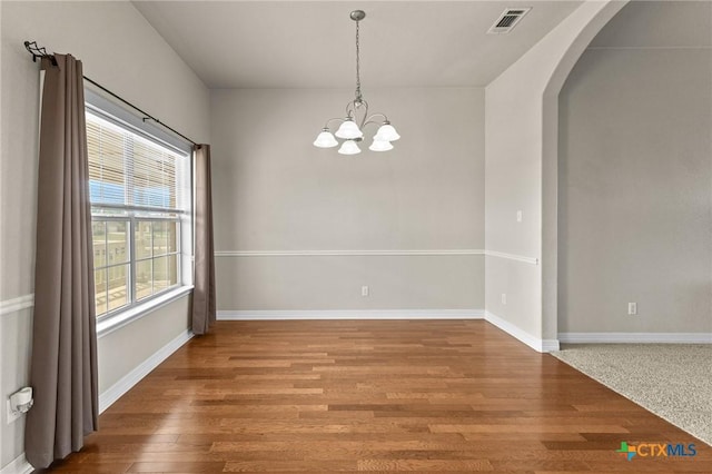 820 Thomas St, Copperas Cove, TX 76522 - spare room with arched walkways, a chandelier, wood finished floors, and baseboards