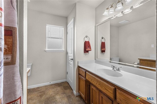 820 Thomas St, Copperas Cove, TX 76522 - bathroom with vanity, toilet, and baseboards