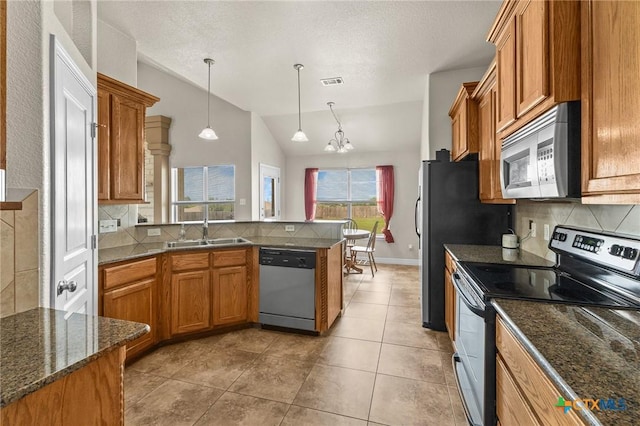820 Thomas St, Copperas Cove, TX 76522 - kitchen featuring appliances with stainless steel finishes, a sink, brown cabinetry, a peninsula, and lofted ceiling