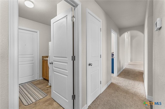820 Thomas St, Copperas Cove, TX 76522 - hall with arched walkways, light colored carpet, and baseboards