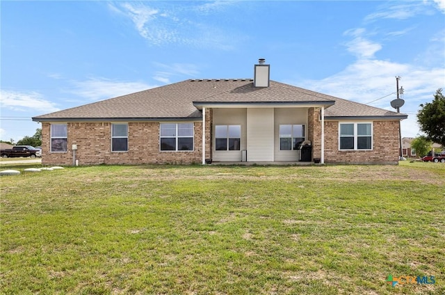 820 Thomas St, Copperas Cove, TX 76522 - back of house featuring a chimney, a lawn, brick siding, and roof with shingles