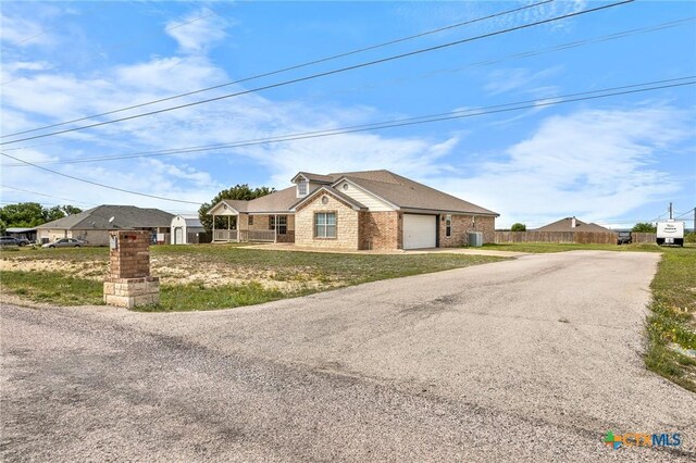 820 Thomas St, Copperas Cove, TX 76522 - ranch-style house featuring asphalt driveway, a garage, and brick siding