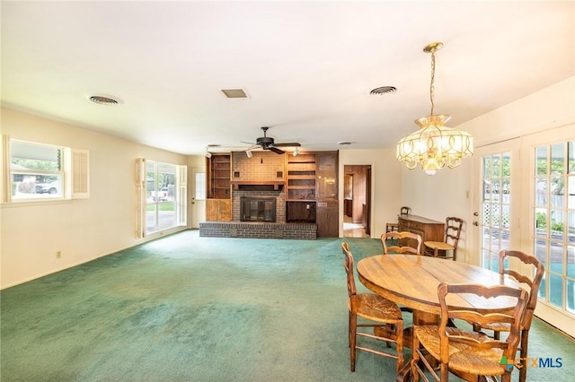 dining space with a fireplace, plenty of natural light, carpet, and visible vents